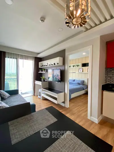 Modern living room with open layout and stylish decor, featuring a cozy bedroom view.