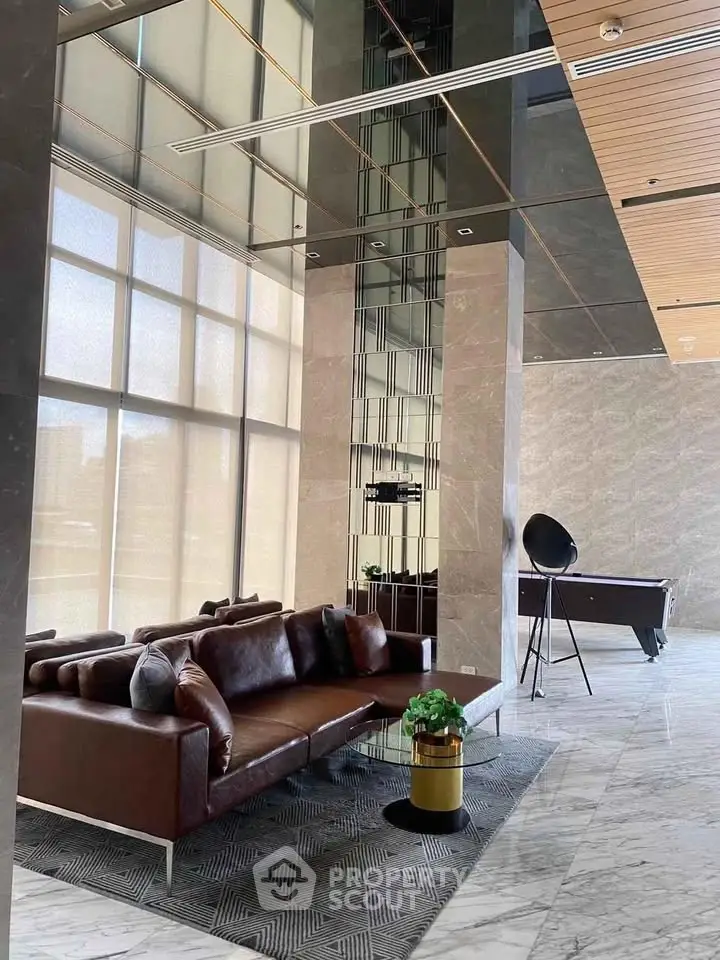 Luxurious modern lobby with elegant seating and marble flooring in a high-end building.