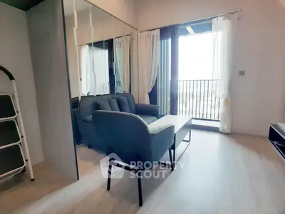 Modern living room with stylish furniture and balcony view, perfect for urban living.