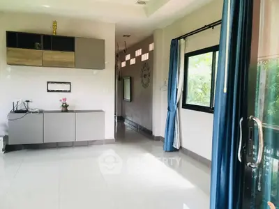 Spacious modern living room with large windows and sleek cabinetry