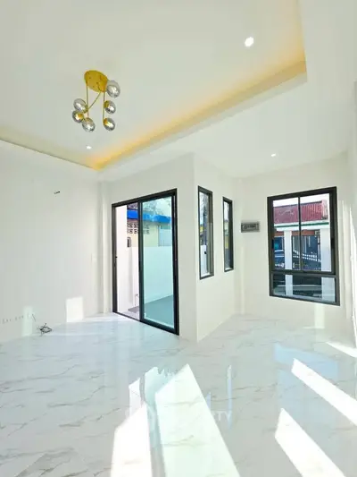 Bright modern living room with marble flooring and stylish lighting in a contemporary home.