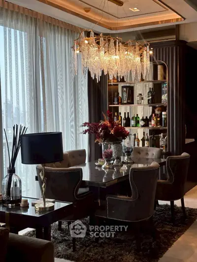 Luxurious dining room with elegant chandelier and stylish decor, perfect for sophisticated gatherings.