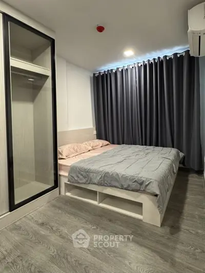Modern bedroom with sleek design, featuring a cozy bed and stylish wardrobe.