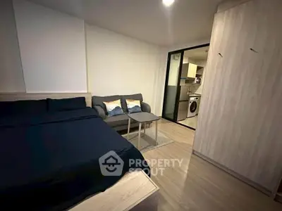 Modern studio apartment with cozy bed and compact living area