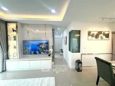 Modern living room with large TV and elegant decor