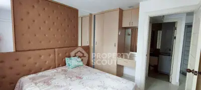 Cozy bedroom with built-in wardrobe and ensuite bathroom in modern apartment.