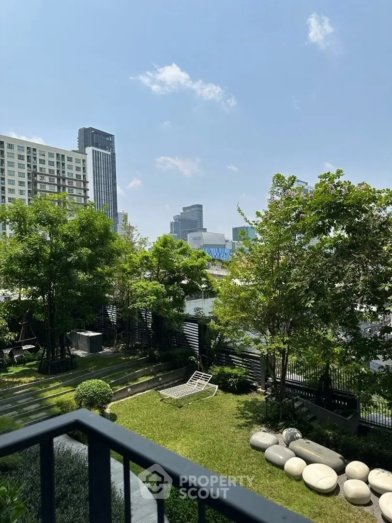 Stunning urban garden view from a modern balcony in a high-rise building.