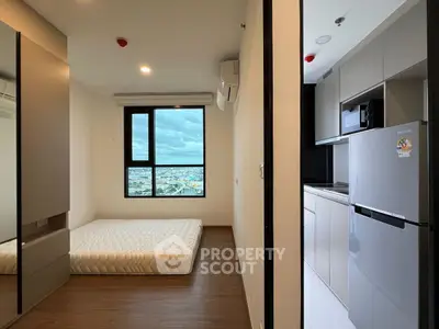 Modern apartment interior with minimalist bedroom and sleek kitchen design.