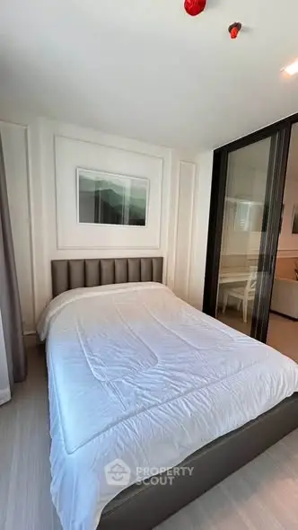 Modern bedroom with sleek design and cozy ambiance, featuring a comfortable bed and stylish decor.