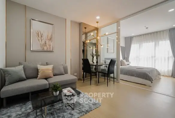 Modern open-plan living room with stylish decor and cozy bedroom view