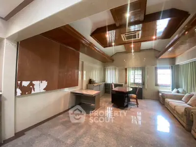 Spacious living room with elegant wooden ceiling and modern furniture
