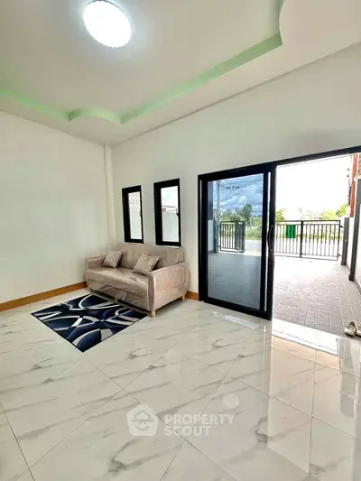 Spacious living room with modern sofa and large balcony access