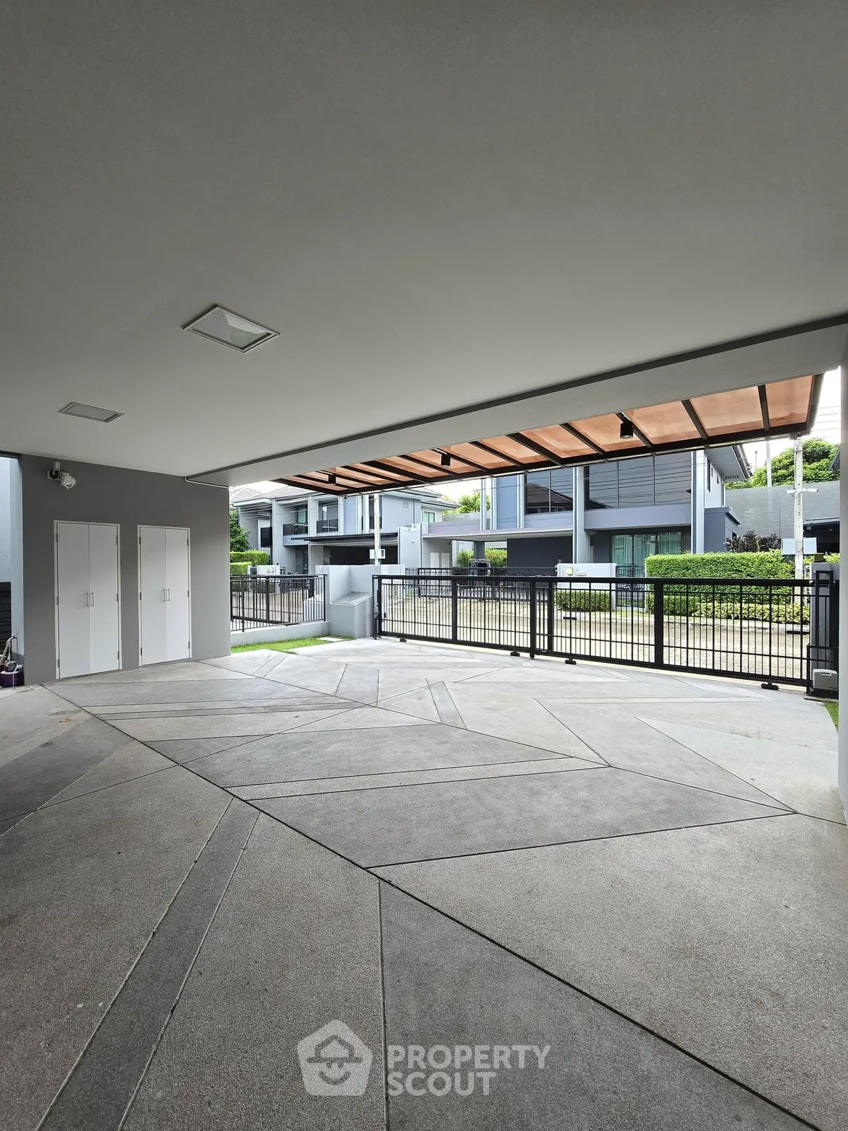 Modern building entrance with sleek design and spacious driveway