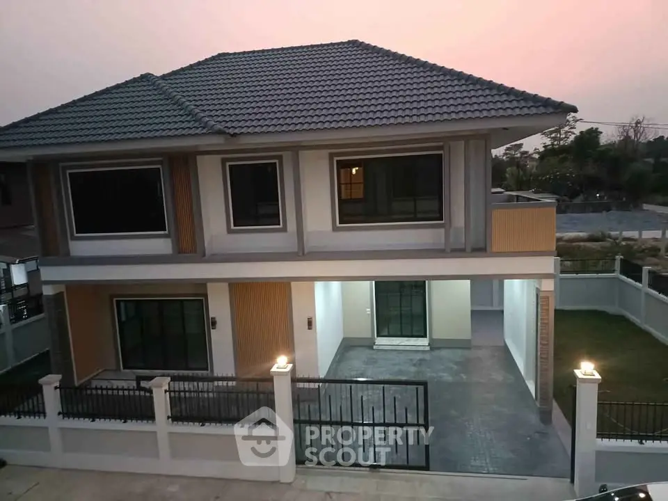 Stunning two-story modern house with spacious driveway and elegant exterior design.