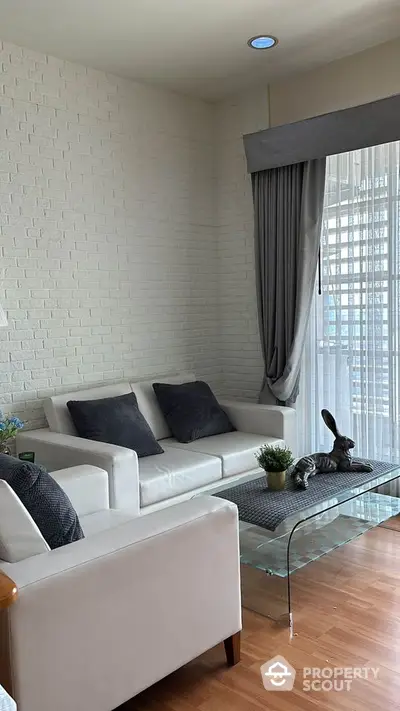 Stylish modern living room with white sofa and glass coffee table