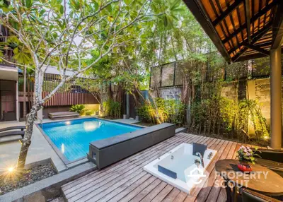 Luxurious outdoor pool area with modern design and lush greenery.