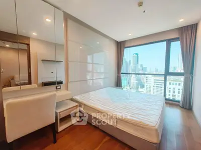 Spacious bedroom with city view in modern high-rise apartment