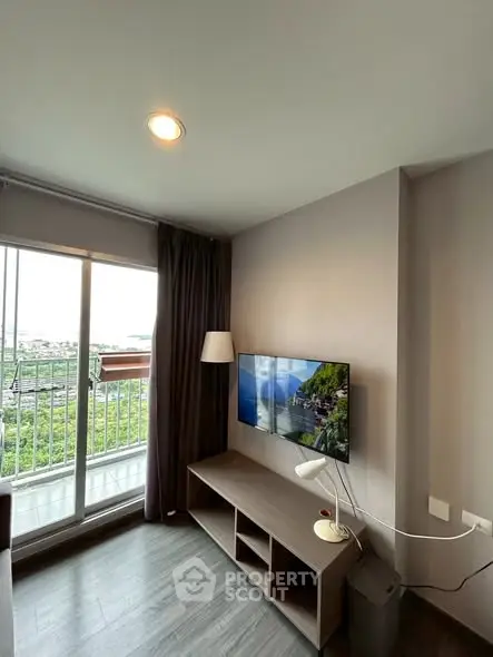 Modern living room with balcony view and wall-mounted TV