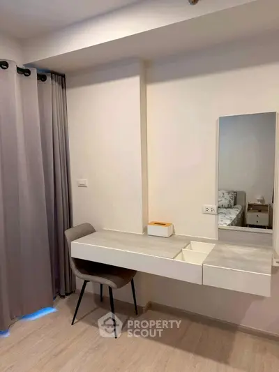 Modern bedroom with sleek vanity and neutral decor