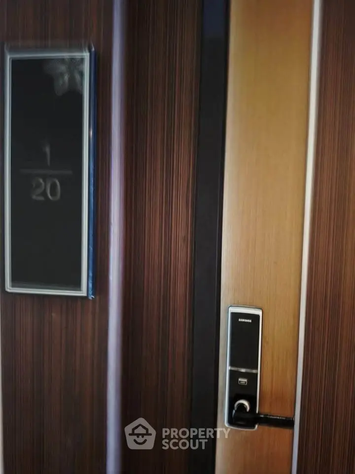 Modern apartment door with electronic lock and sleek wood finish