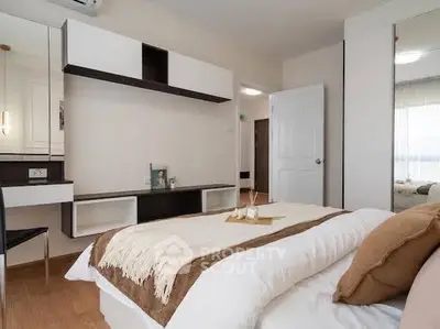 Cozy bedroom with modern decor and natural light, featuring a comfortable bed and stylish shelving.