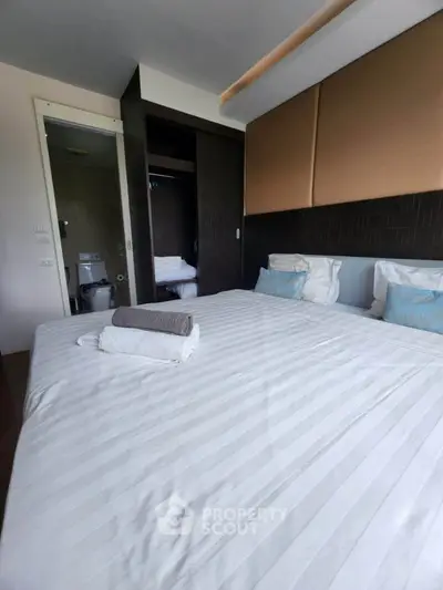 Cozy bedroom with ensuite bathroom in modern apartment