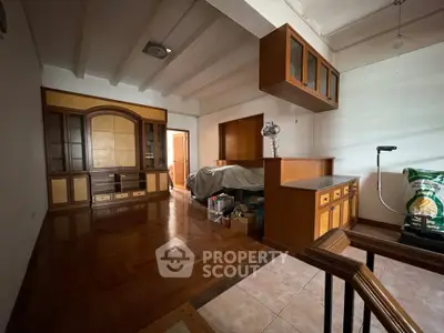 Spacious living room with wooden cabinetry and parquet flooring, ideal for cozy family gatherings.