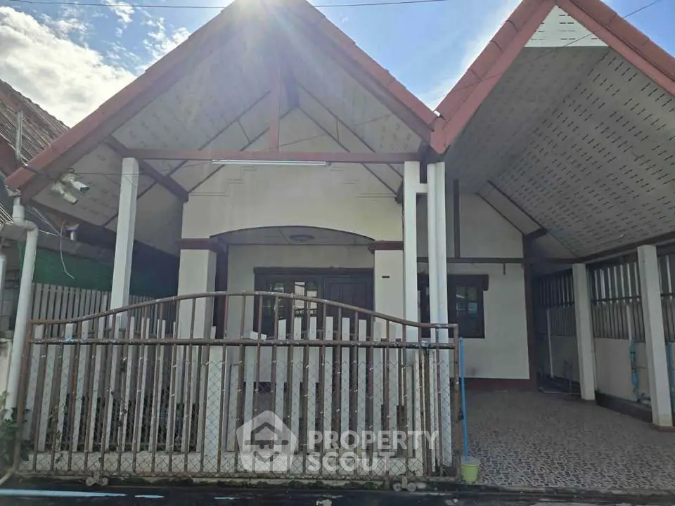 Charming single-story house with a gated entrance and spacious front area, perfect for family living.