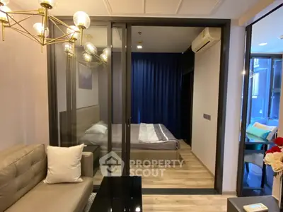 Modern apartment interior with glass-walled bedroom and stylish living area