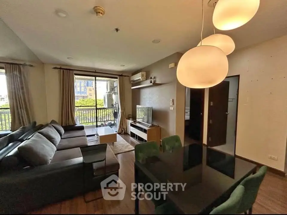 Spacious living room with modern furniture and large windows offering natural light.