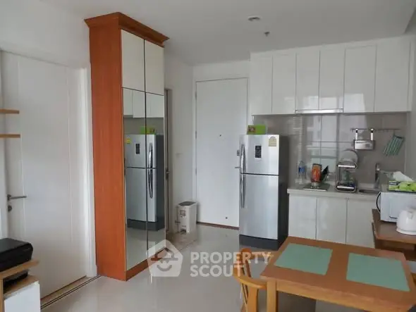 Modern kitchen with sleek appliances and dining area in a stylish apartment