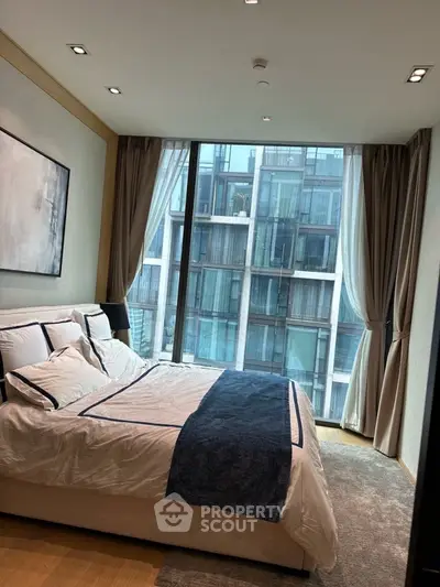 Luxurious bedroom with floor-to-ceiling windows and modern decor in urban apartment.