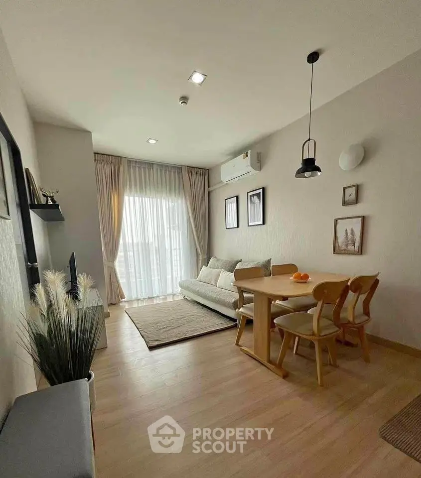 Stylish living room with modern decor and natural light, featuring a cozy dining area and elegant furnishings.