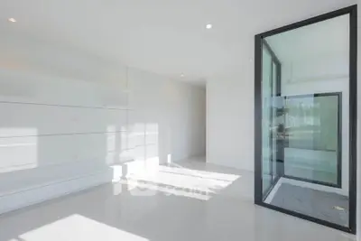Spacious modern interior with large windows and sleek design, perfect for natural light lovers.