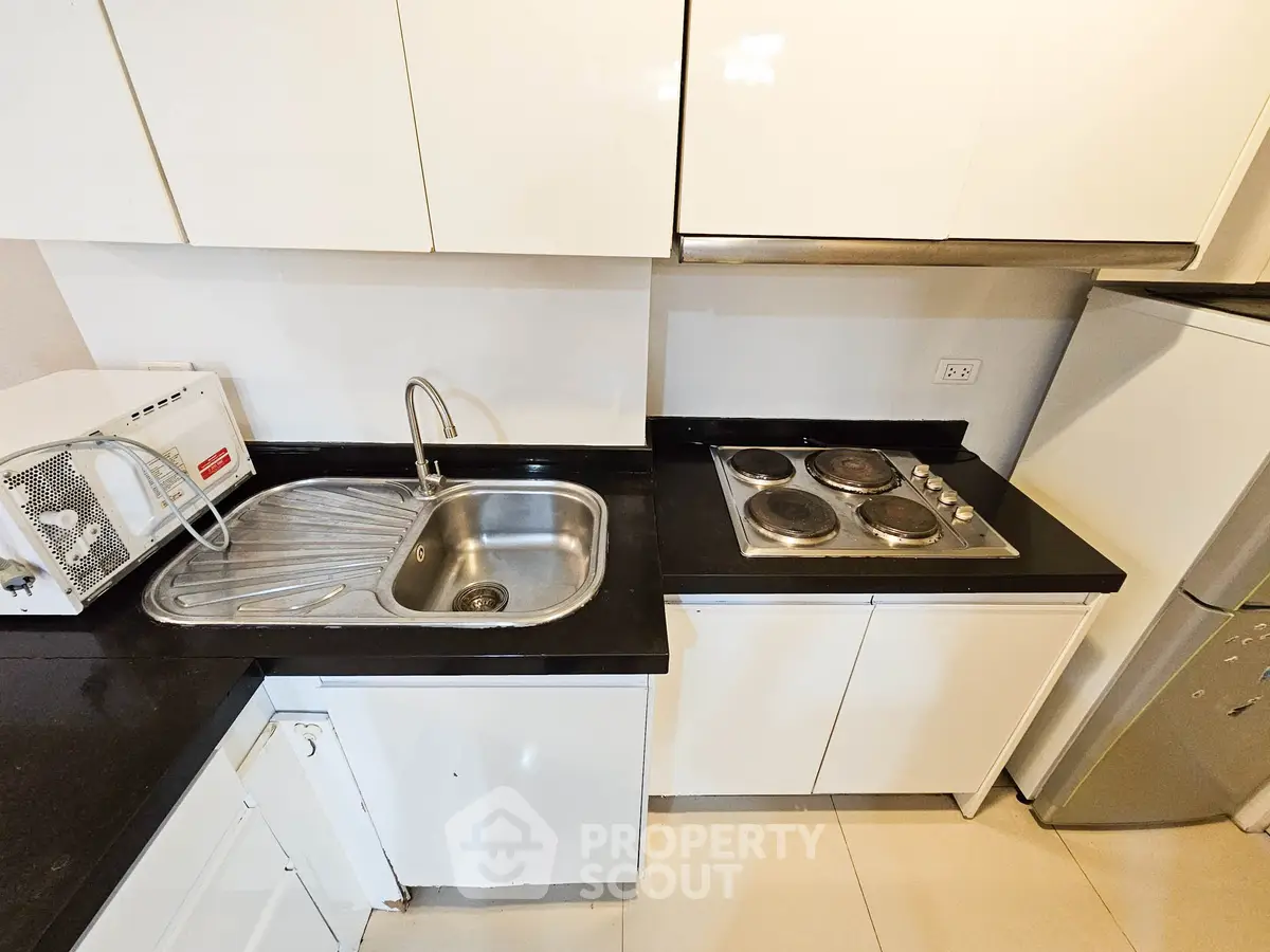 Modern kitchen with sleek black countertops and built-in electric stove