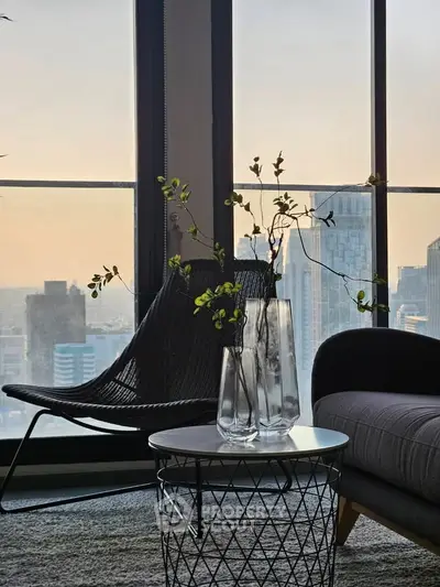 Stylish modern living room with city view, featuring elegant furniture and decor.