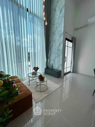 Luxurious modern living room with high ceilings and elegant decor