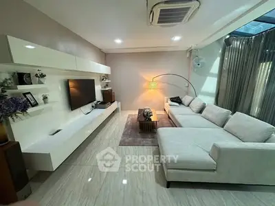 Spacious modern living room with sleek design and cozy seating area.