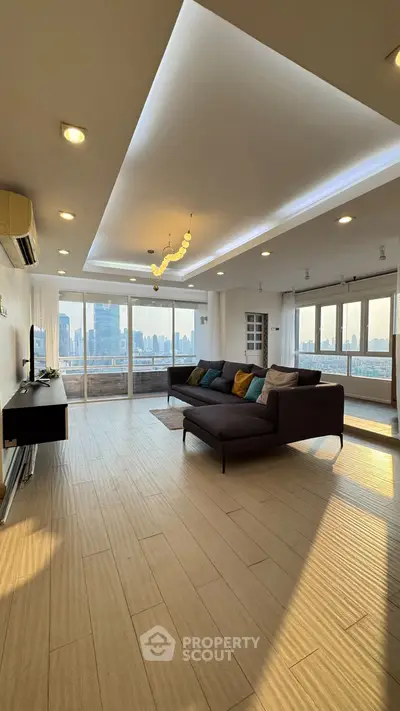 Spacious modern living room with panoramic city views and elegant lighting