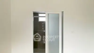 Minimalist bathroom with sliding glass door and modern tile design