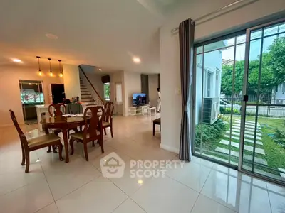 Spacious open-plan living and dining area with garden view in modern home