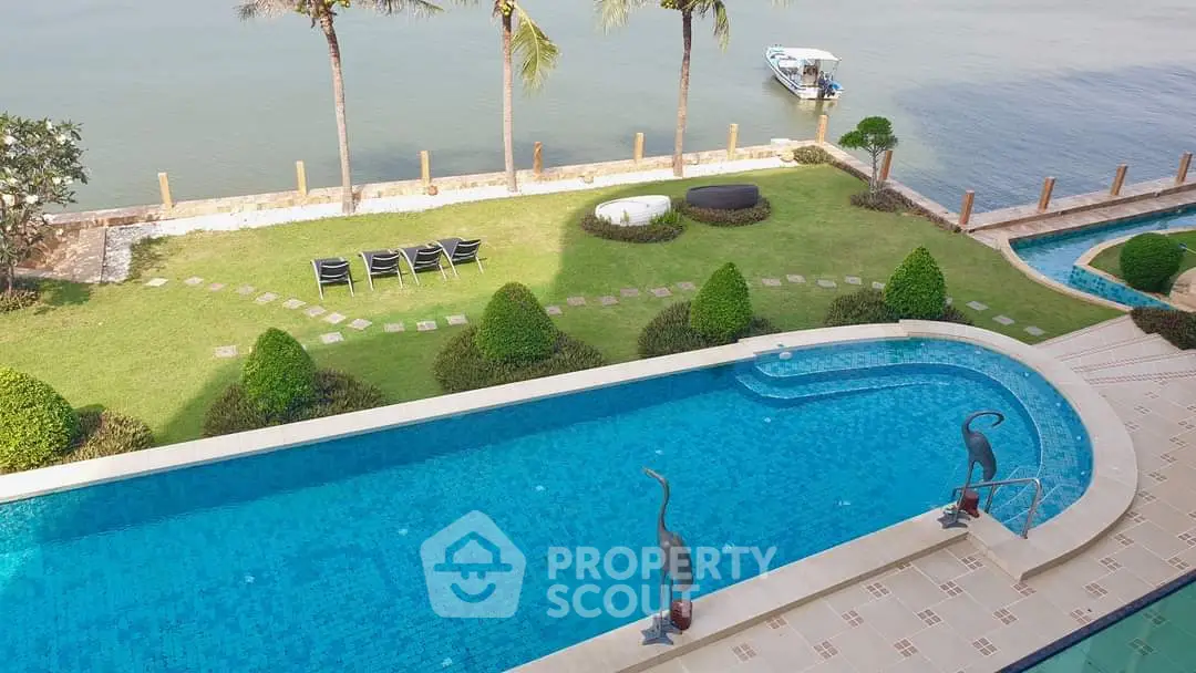 Luxurious waterfront property with stunning pool and serene river view, perfect for relaxation and leisure.