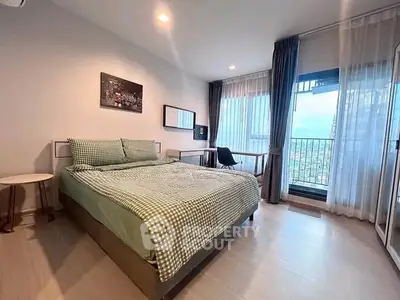 Spacious bedroom with large windows and scenic view, modern decor and natural light.