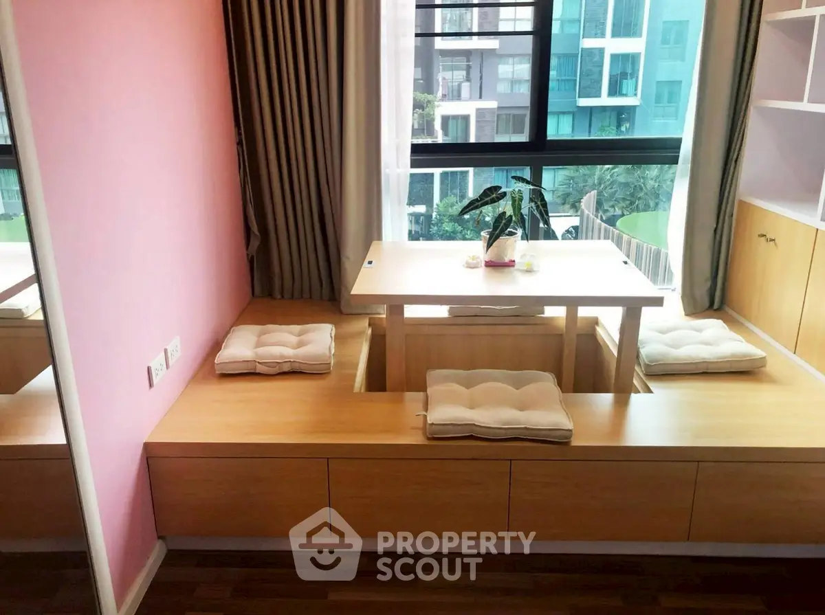 Modern apartment with cozy built-in seating and large window view