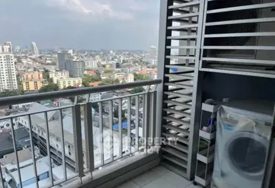 High-rise balcony with cityscape view and washing machine setup.