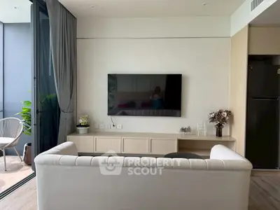 Modern living room with sleek TV setup and balcony view, perfect for urban living.