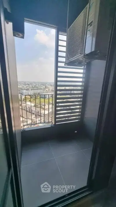 Modern balcony with city view and air conditioning unit, perfect for urban living.