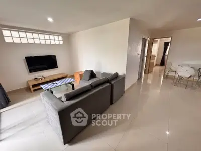Spacious living room with modern furniture and sleek tile flooring