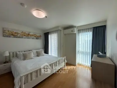 Bright and airy bedroom with modern decor and large windows in a stylish apartment.