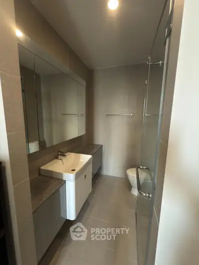 Modern bathroom with sleek fixtures and glass shower enclosure